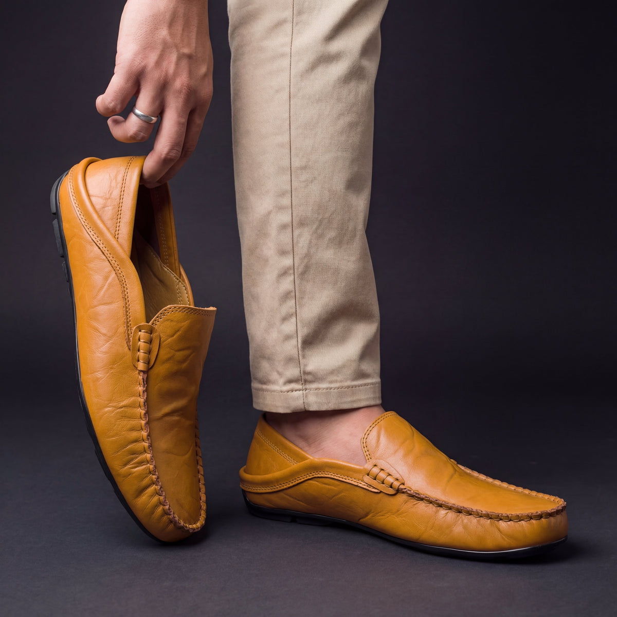 Unisex slip-on moc toe loafers with stitched apron detailing and flat soles