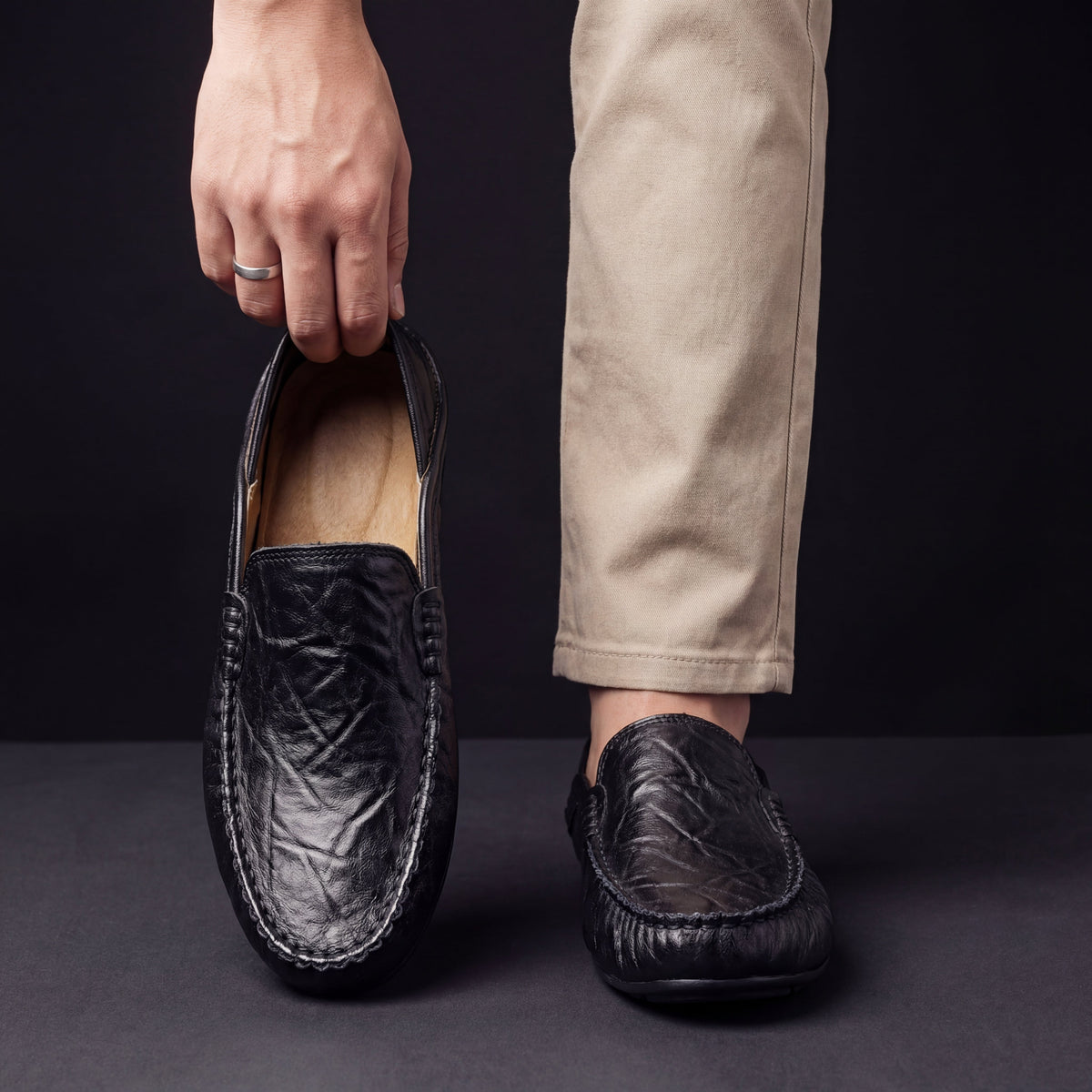 Unisex slip-on moc toe loafers with stitched apron detailing and flat soles
