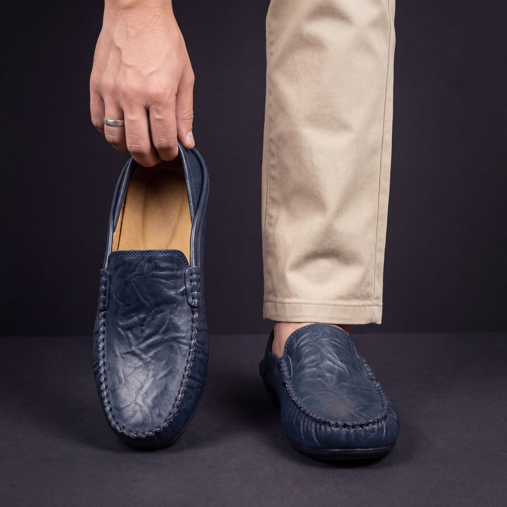 Unisex slip-on moc toe loafers with stitched apron detailing and flat soles