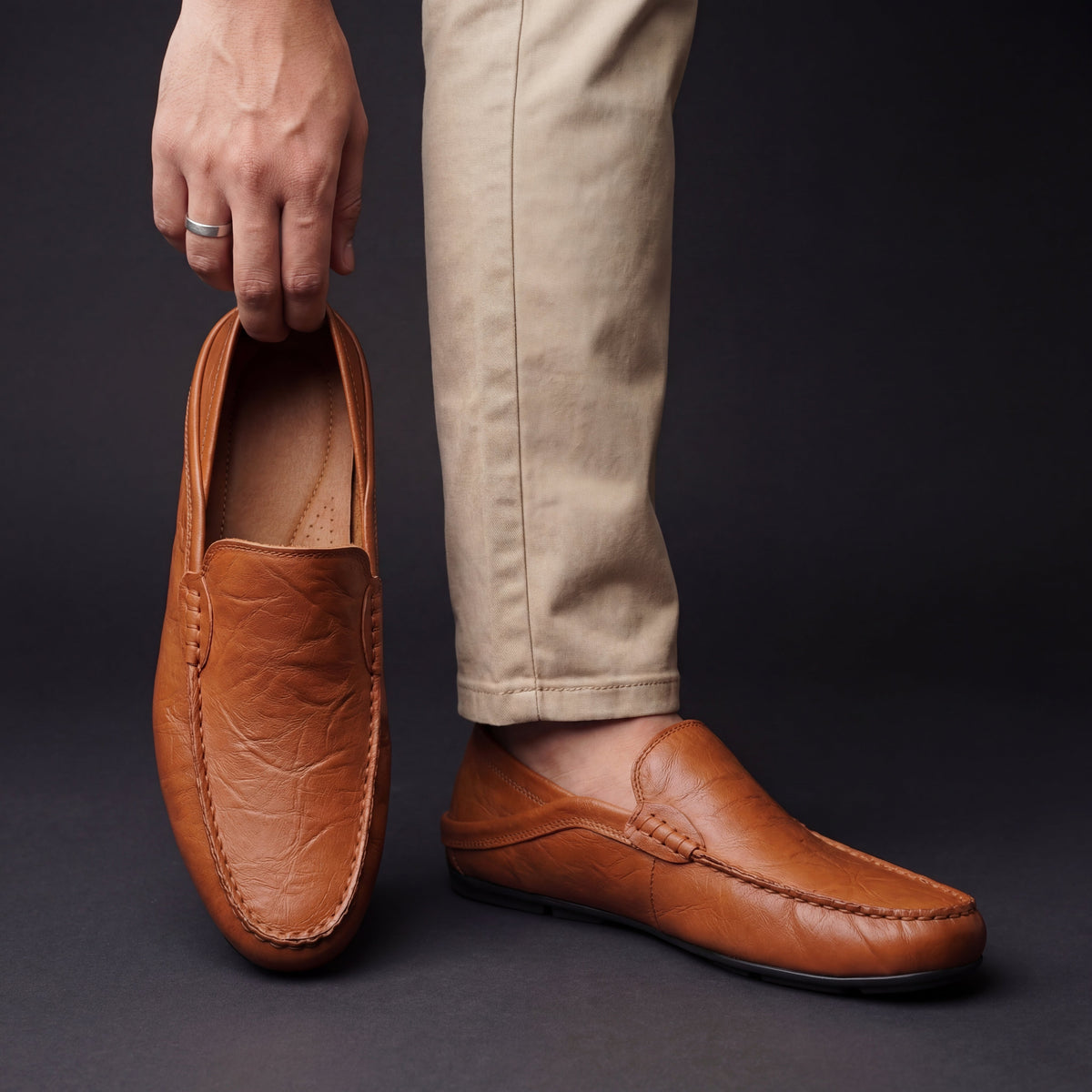Unisex slip-on moc toe loafers with stitched apron detailing and flat soles
