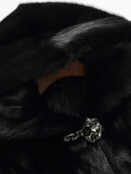 Women's black faux fur hooded coat with long sleeves and flared mid-calf shape