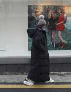 Women's long quilted puffer coat with hood and side pockets