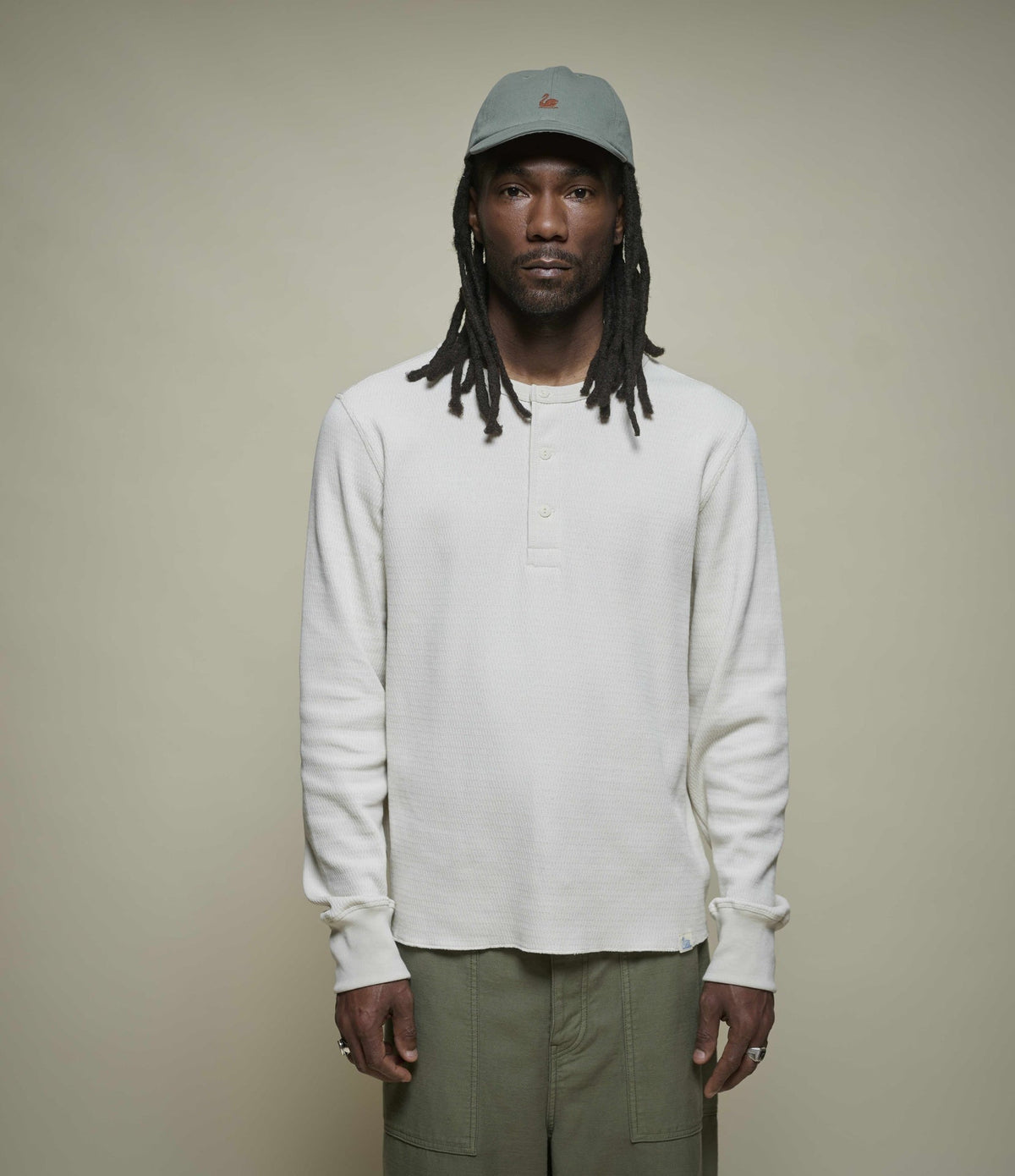 Men's cream long sleeve Henley shirt with round neckline and button placket