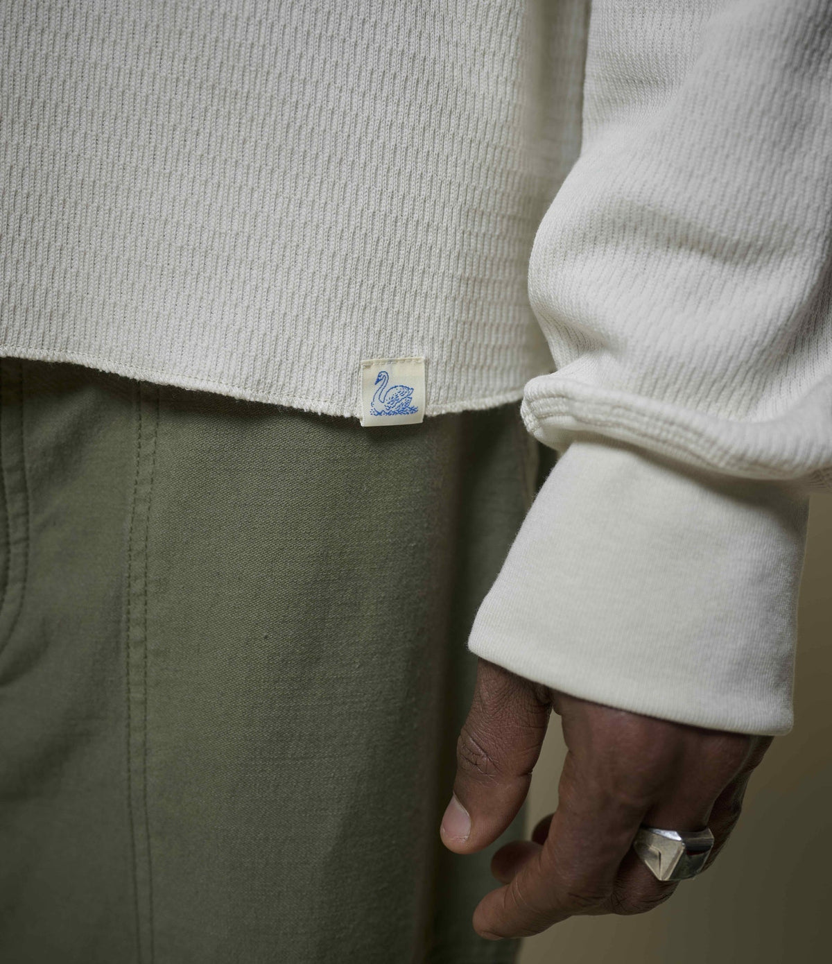 Men's cream long sleeve Henley shirt with round neckline and button placket