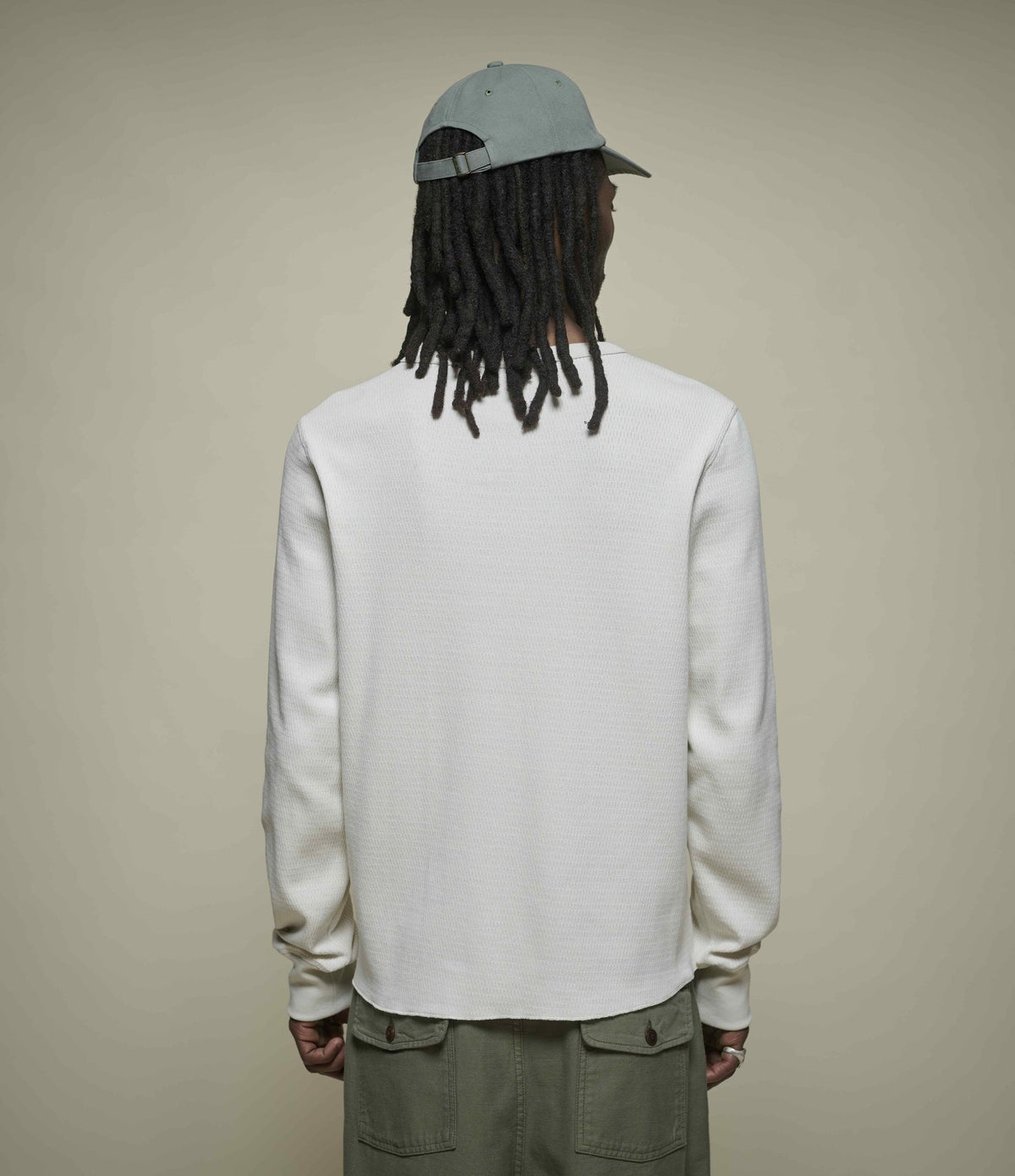 Men's cream long sleeve Henley shirt with round neckline and button placket