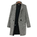 Women's long black and white herringbone coat with notched collar and button fastening