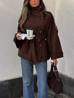 Women's brown double-breasted trench jacket with high collar and waist belt
