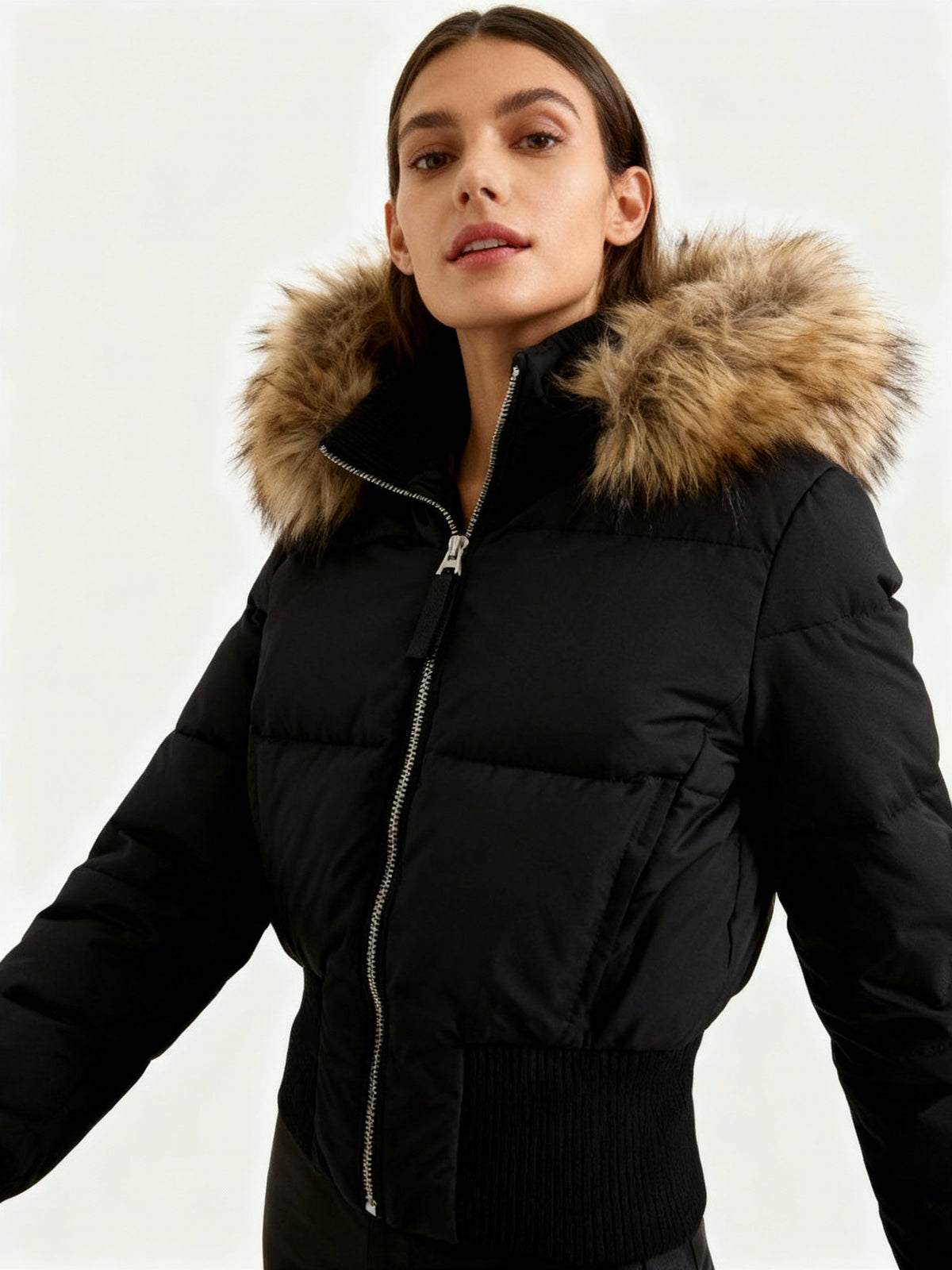 Women's quilted hooded puffer jacket with faux fur trim and zipped pockets