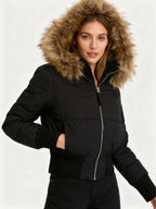 Women's quilted hooded puffer jacket with faux fur trim and zipped pockets