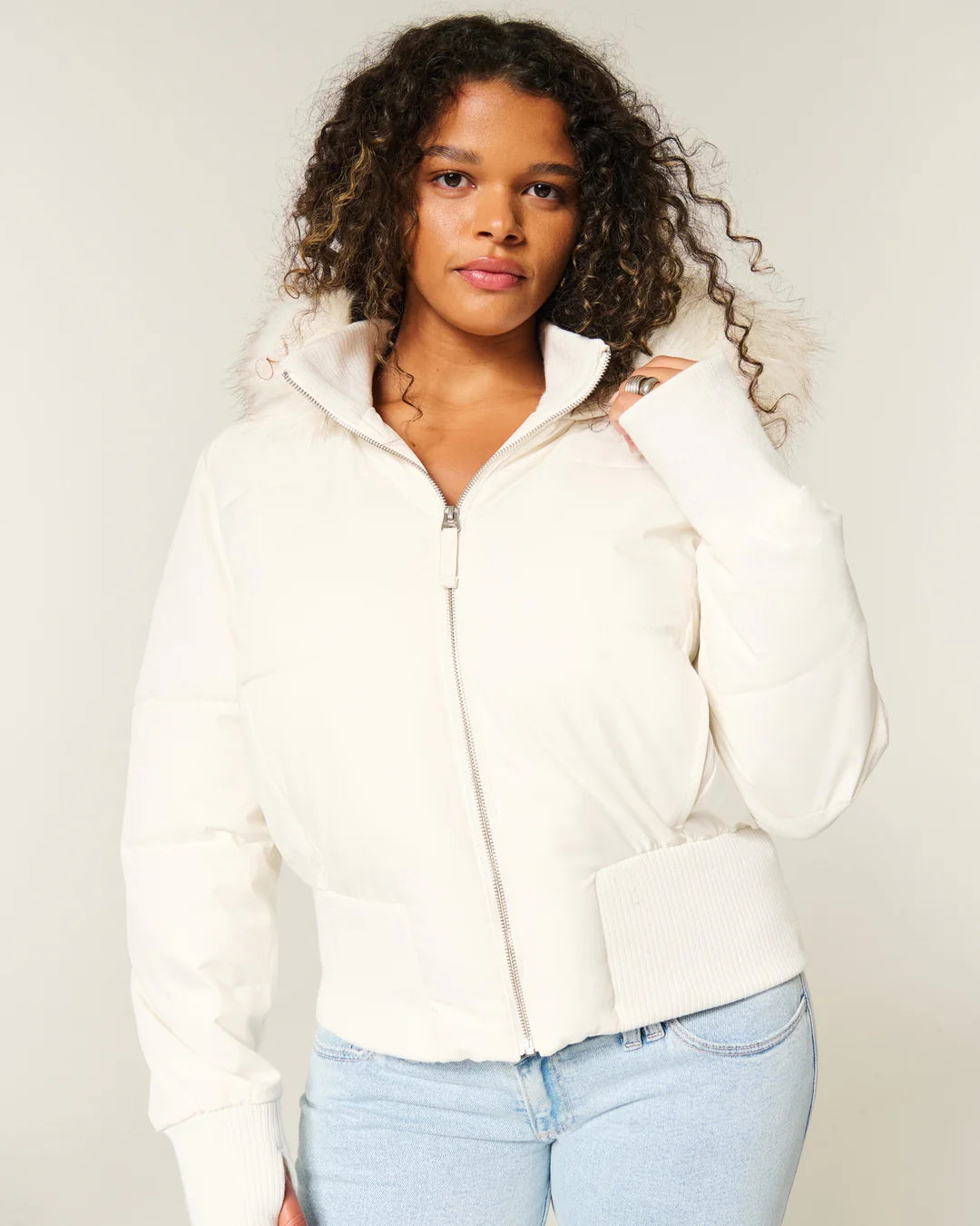 Women's quilted hooded puffer jacket with faux fur trim and zipped pockets