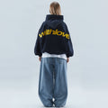 Women's oversized hooded sweatshirt with long sleeves and large back text graphic