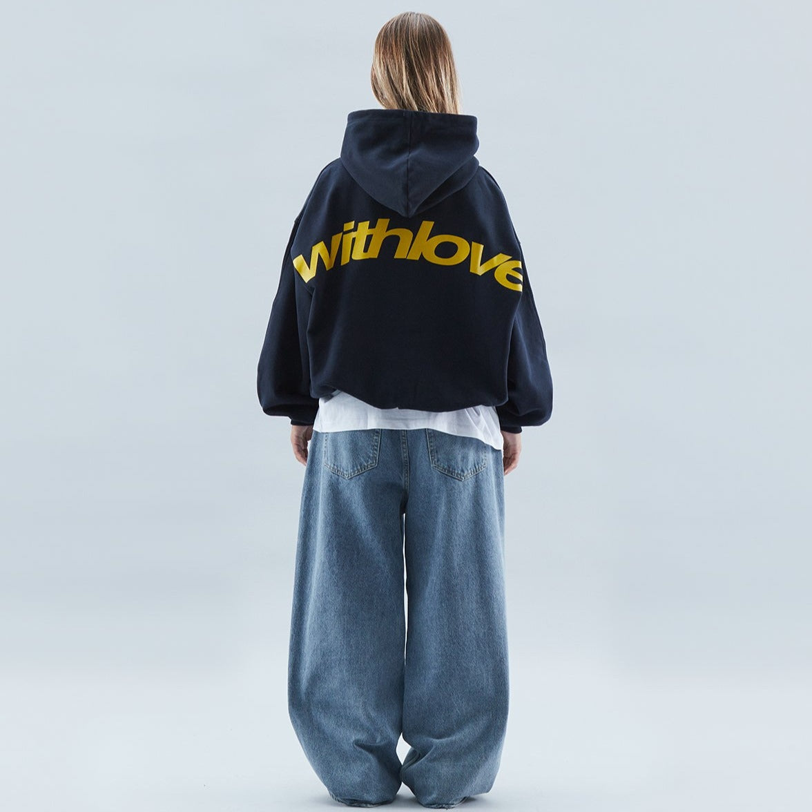 Women's oversized hooded sweatshirt with long sleeves and large back text graphic