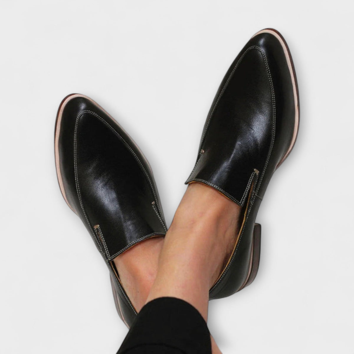 Women's black pointed loafers with stitch detailing and low heels