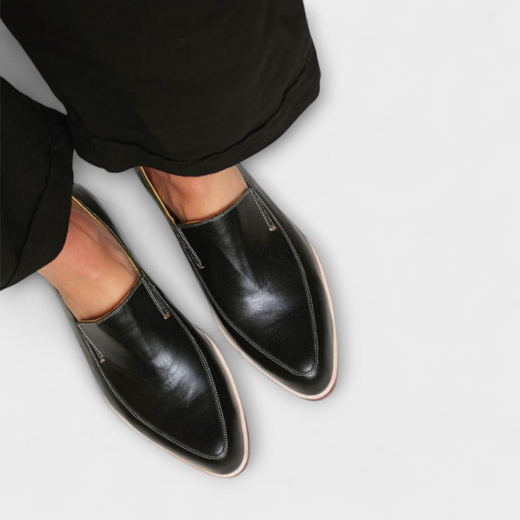 Women's black pointed loafers with stitch detailing and low heels