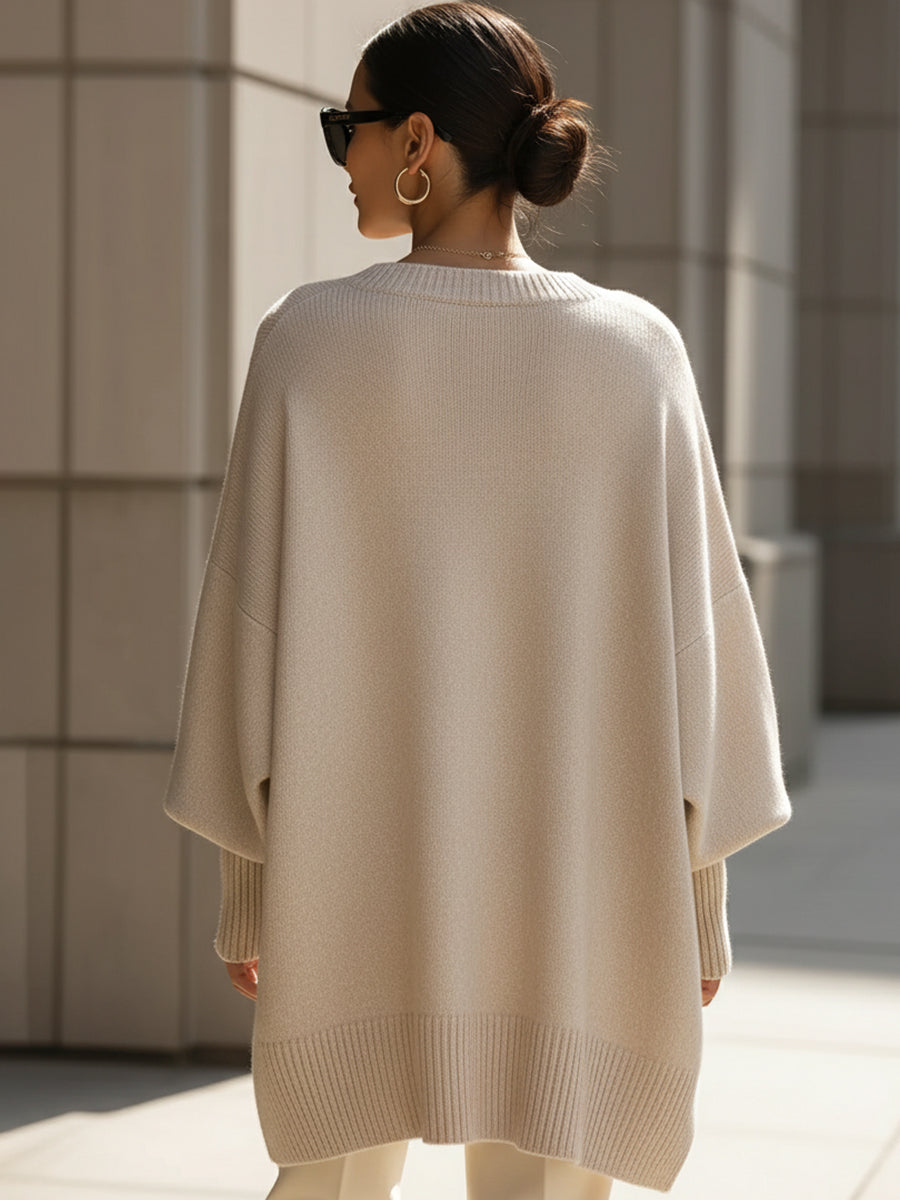 Women's oversized knitted jumper with crew neck, long sleeves and asymmetric hem