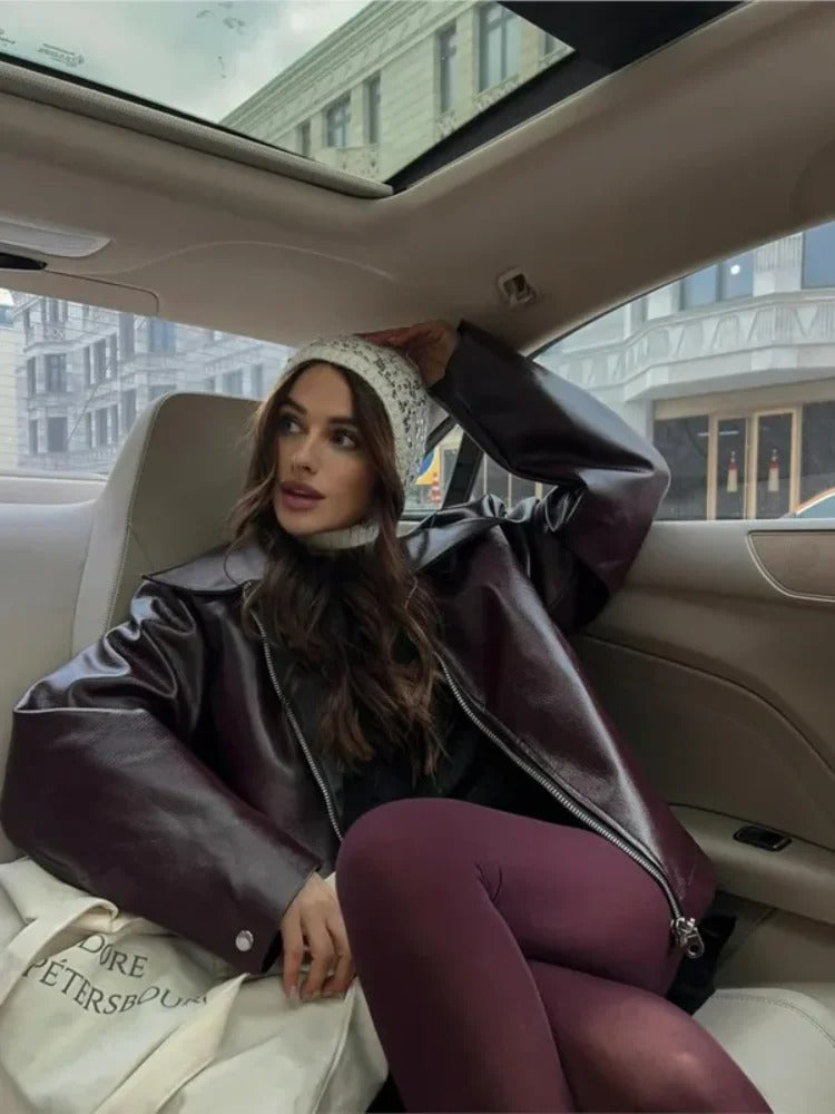 Women's burgundy oversized jacket with wide lapels, structured shoulders and a waist belt