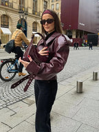 Women's burgundy oversized jacket with wide lapels, structured shoulders and a waist belt