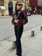 Women's burgundy oversized jacket with wide lapels, structured shoulders and a waist belt