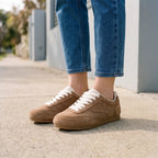 Women's plain low-top lace-up trainers with textured panels and flat soles