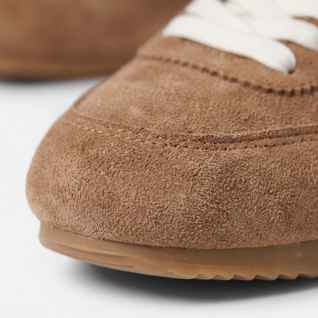 Women's plain low-top lace-up trainers with textured panels and flat soles