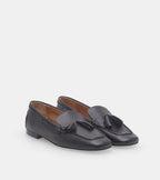 Women's black slip-on loafers with tassel detailing and low heels