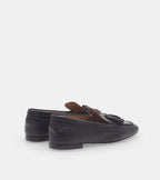 Women's black slip-on loafers with tassel detailing and low heels