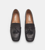Women's black slip-on loafers with tassel detailing and low heels