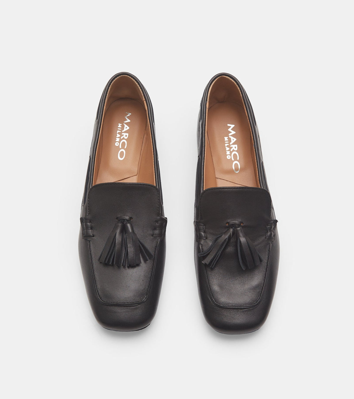 Women's black slip-on loafers with tassel detailing and low heels