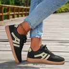 Women's low-top lace-up trainers with panelled side stripes and flat textured soles