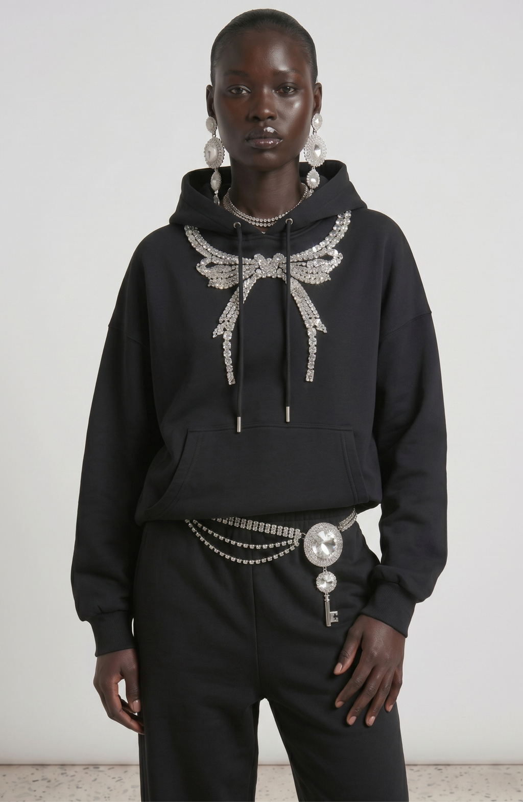 Black hoodie with embellished wing graphic, drawstring hood and kangaroo pocket