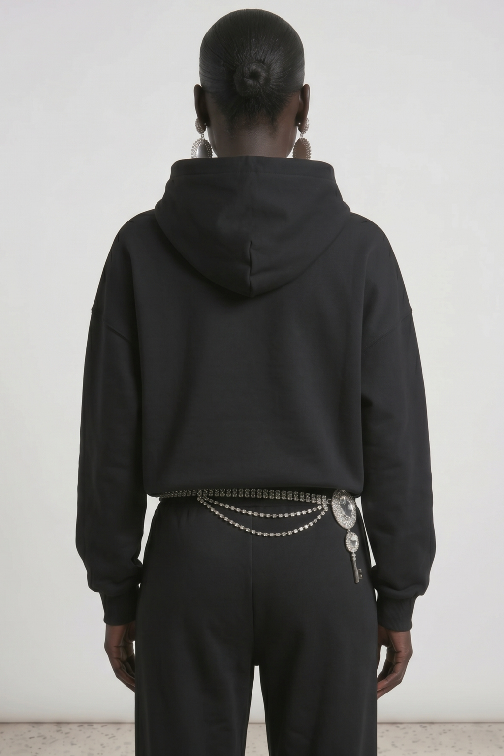 Black hoodie with embellished wing graphic, drawstring hood and kangaroo pocket