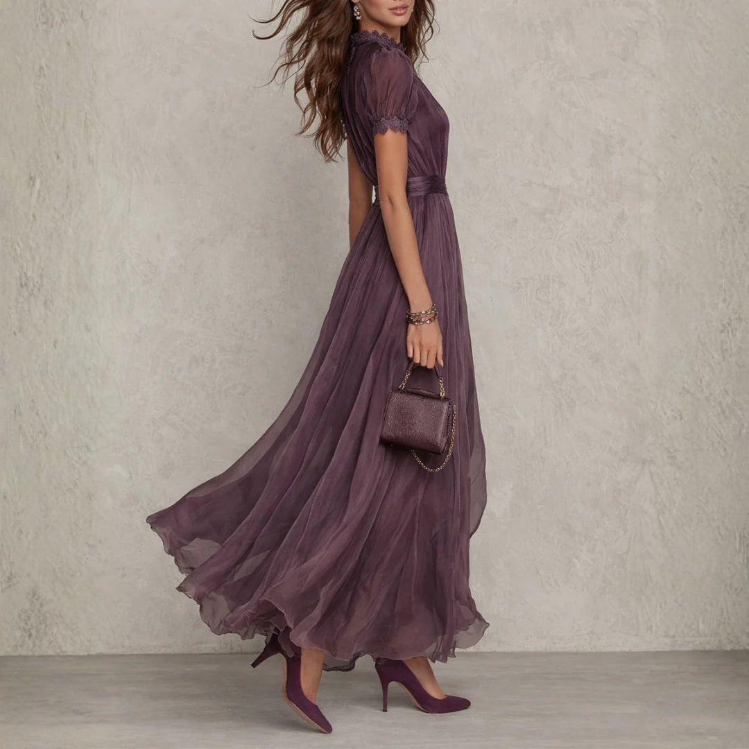 Women's purple chiffon maxi dress with high neckline, short puff sleeves and flowing full-length skirt