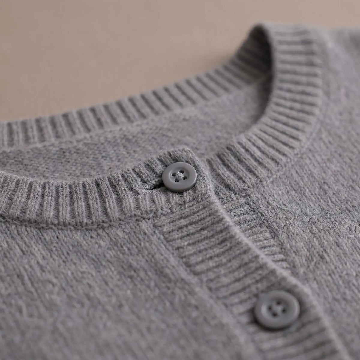 Women's grey fine knit cardigan with round neck and button front