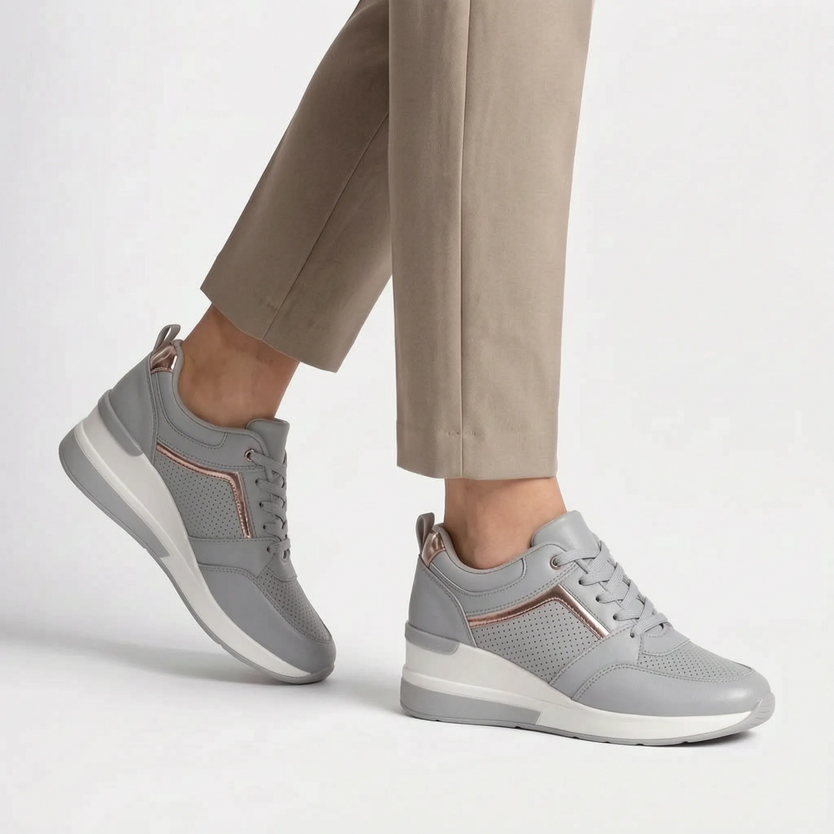 Women's lace-up wedge trainers with perforated panels and raised soles