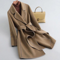 Women's long belted trench coat with wide lapels and contrast piping