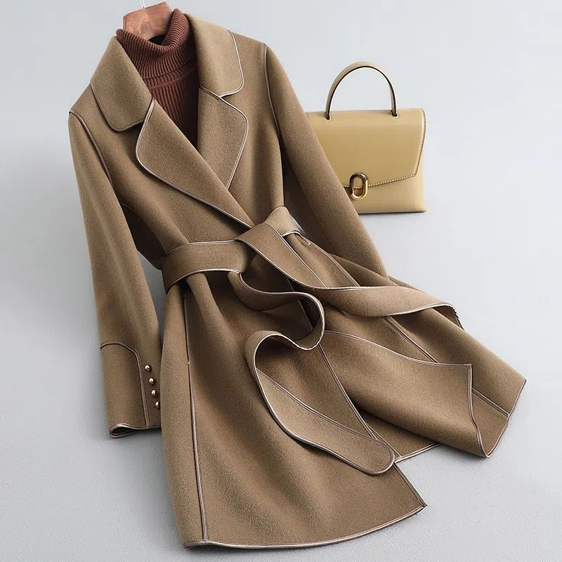 Women's long belted trench coat with wide lapels and contrast piping