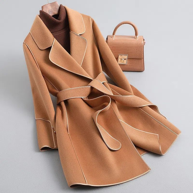 Women's long belted trench coat with wide lapels and contrast piping