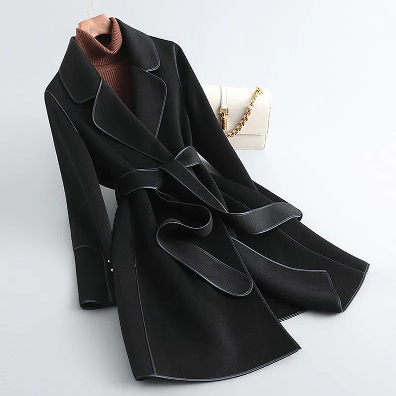 Women's long belted trench coat with wide lapels and contrast piping