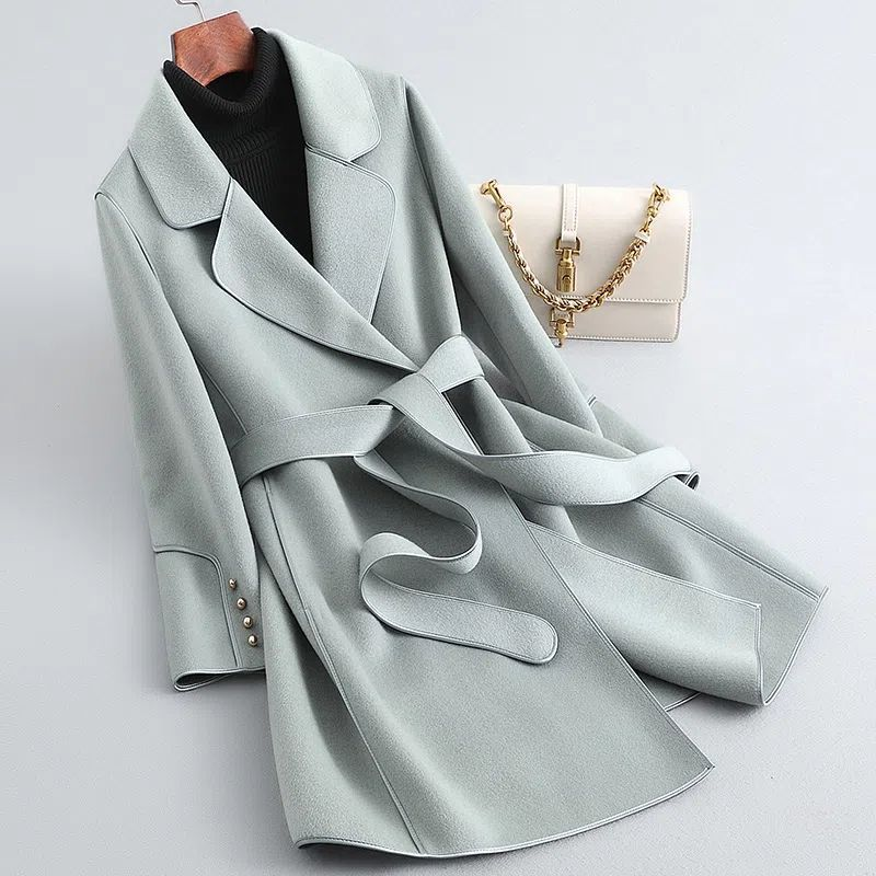 Women's long belted trench coat with wide lapels and contrast piping