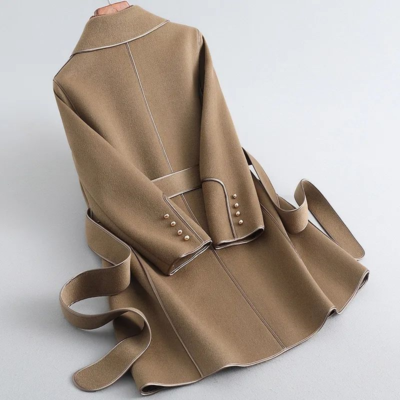 Women's long belted trench coat with wide lapels and contrast piping