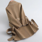 Women's long belted trench coat with wide lapels and contrast piping