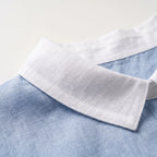 Women's light blue short-sleeved blouse with contrasting white rounded collar and curved hem