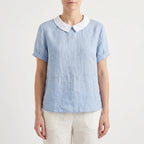 Women's light blue short-sleeved blouse with contrasting white rounded collar and curved hem