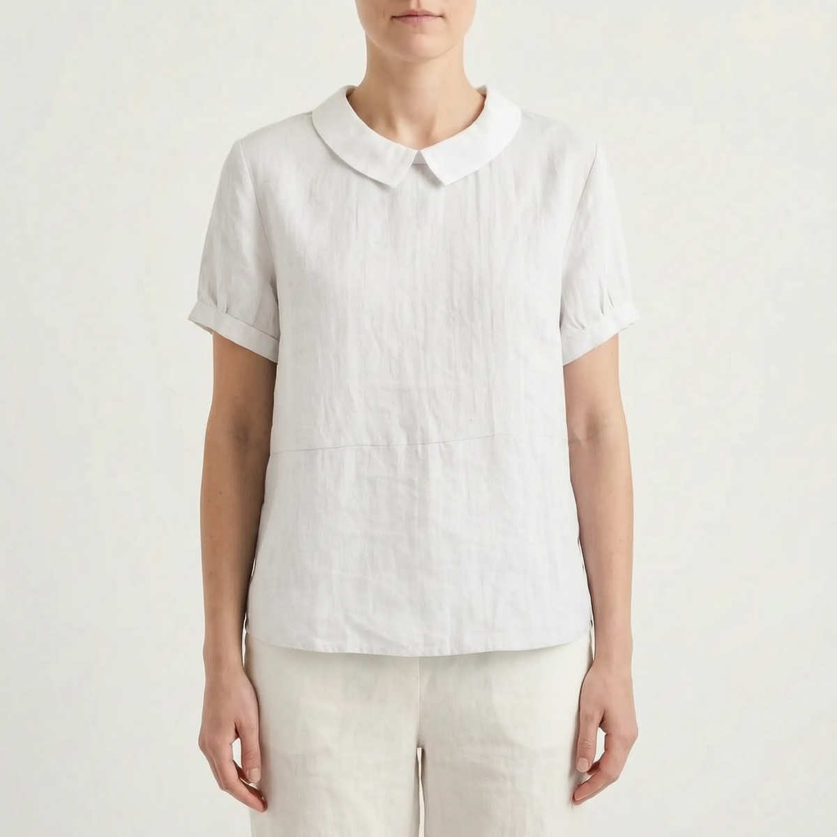 Women's light blue short-sleeved blouse with contrasting white rounded collar and curved hem