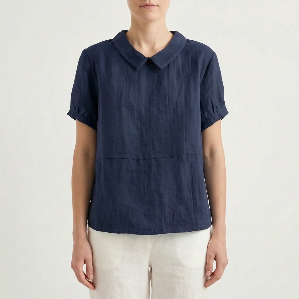 Women's light blue short-sleeved blouse with contrasting white rounded collar and curved hem