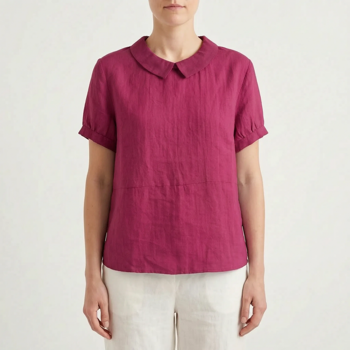 Women's light blue short-sleeved blouse with contrasting white rounded collar and curved hem