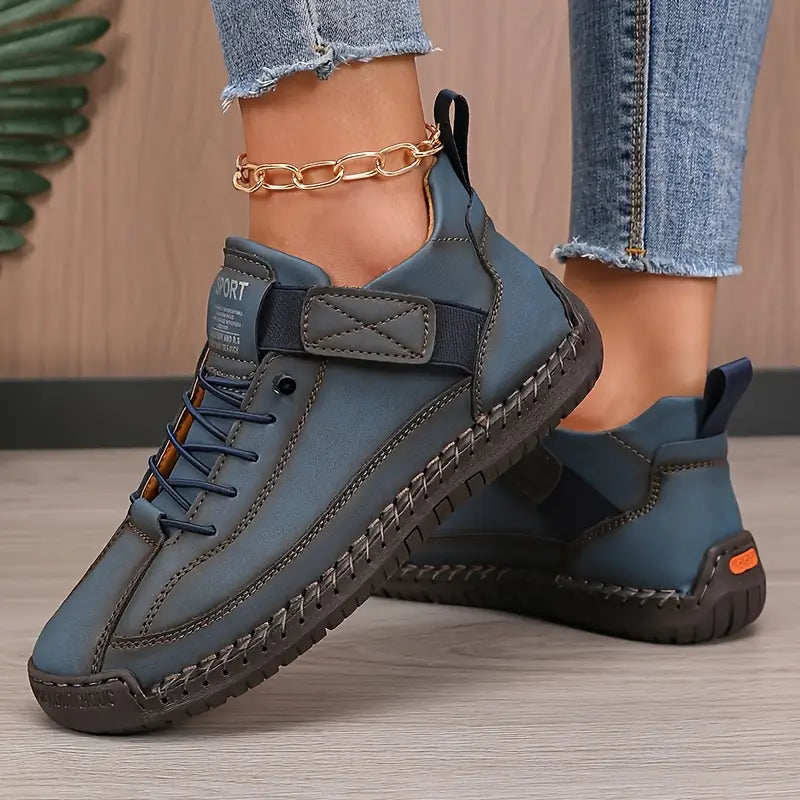 Women's high-top lace-up trainers with stitched panels and flat soles