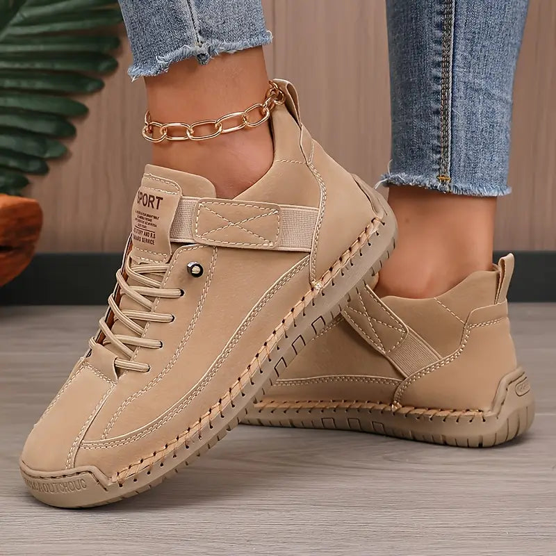 Women's high-top lace-up trainers with stitched panels and flat soles