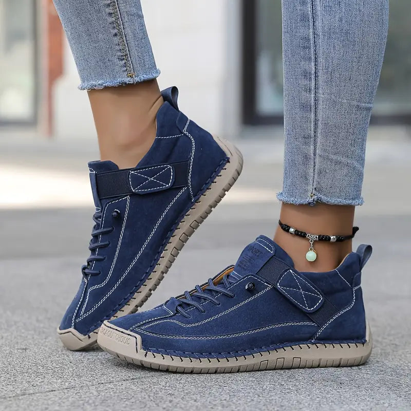 Women's high-top lace-up trainers with stitched panels and flat soles