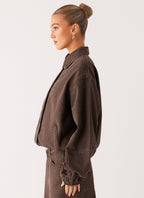 Women's brown washed denim bomber jacket with collar and cropped fit